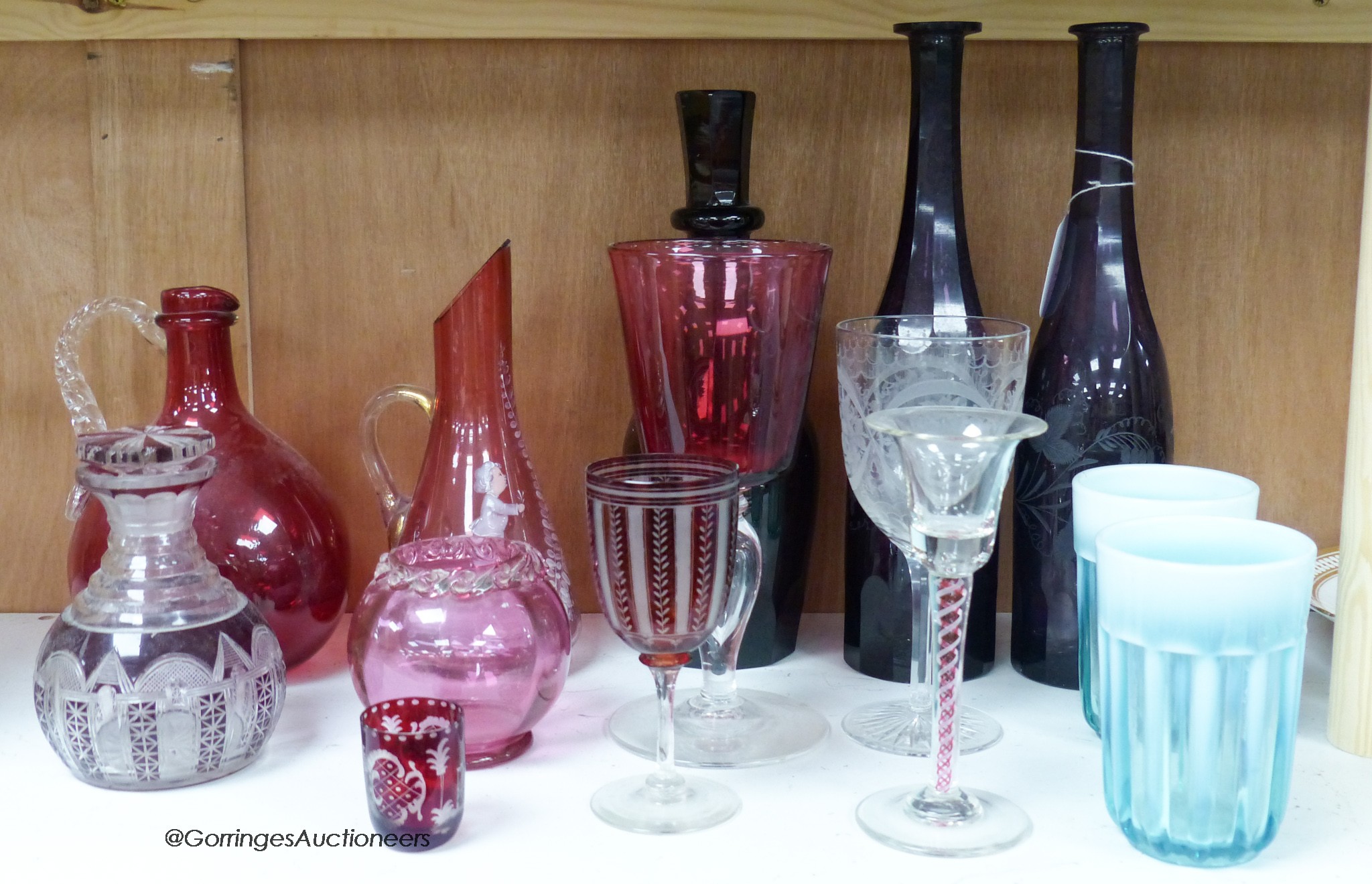 A pair of amethyst glass decanters, cranberry glass and mixed 19th and 20th century coloured glassware